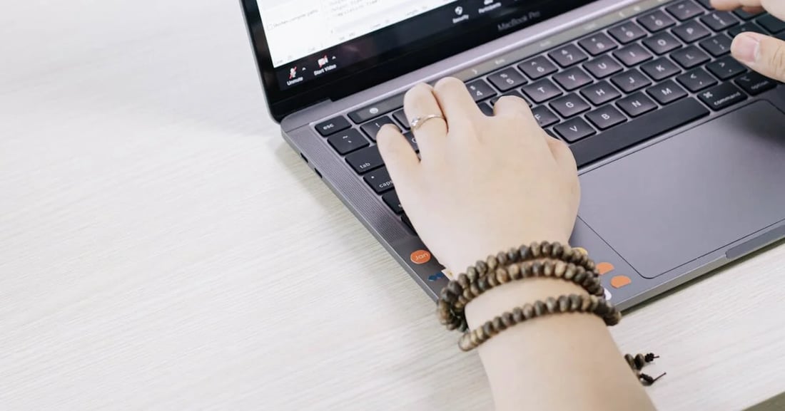 Person writing blog content on a laptop representing modern blogging trends