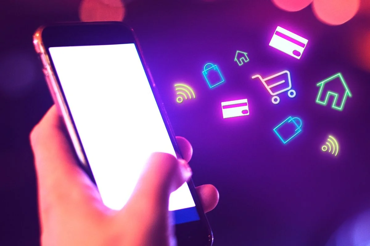 Person browsing an ecommerce store on a smartphone with shopping icons overlay
