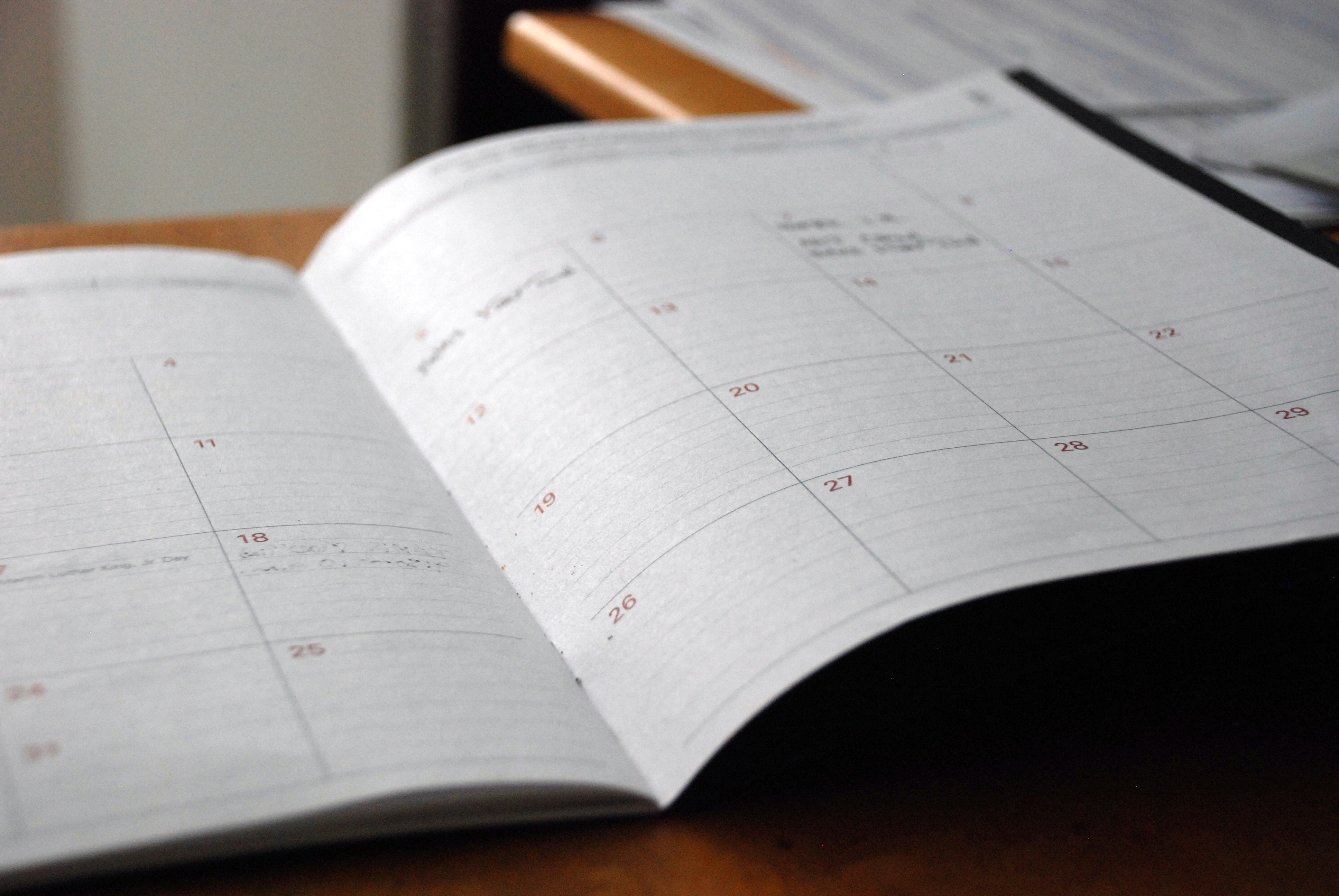 Weekly planner mapped out on a desk, representing a course launch action plan for launch week