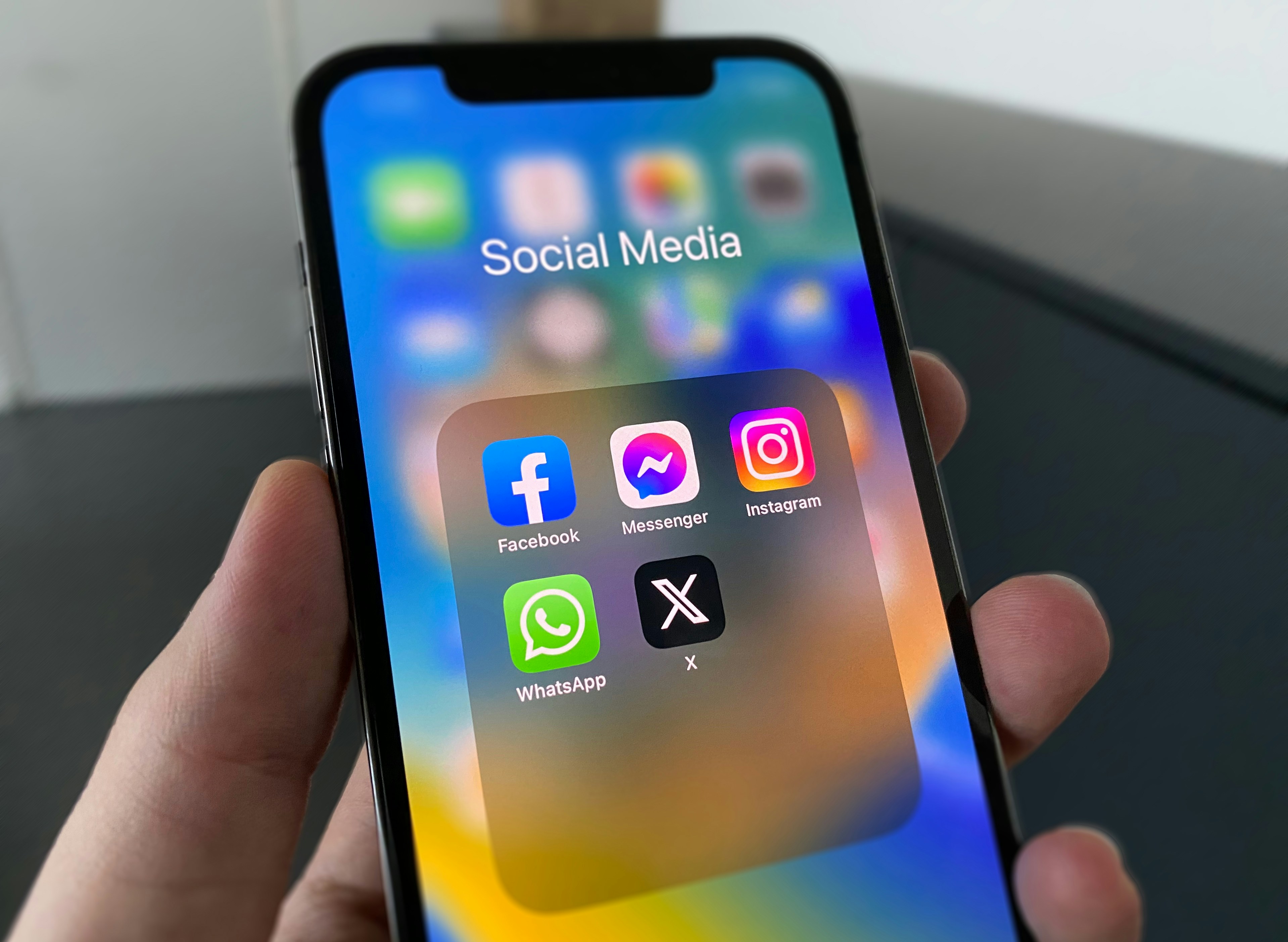 Phone screen displaying social media app icons, representing WordPress social media feed plugins