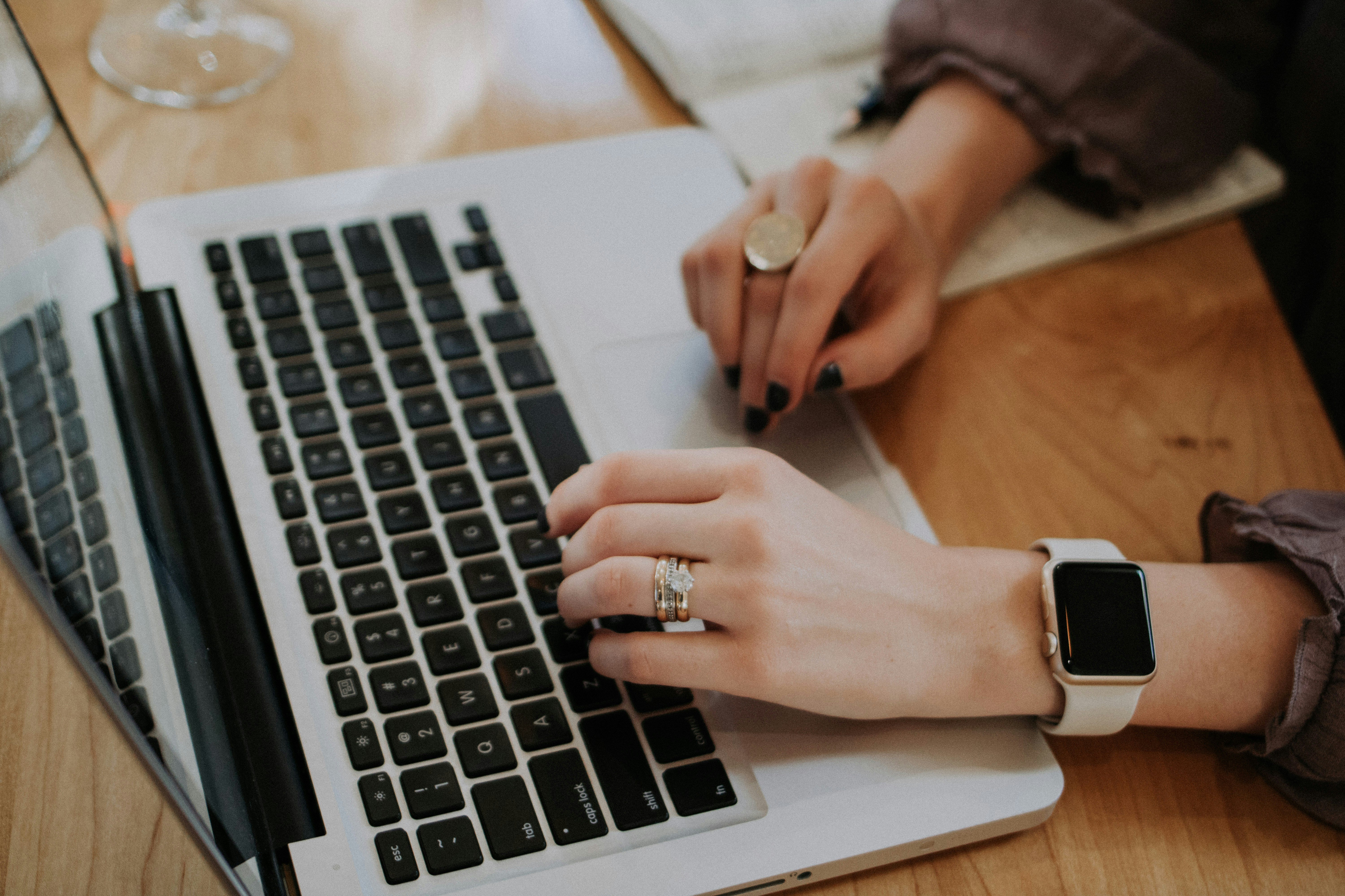 A person writing content on a laptop, representing WordPress content creation plugins