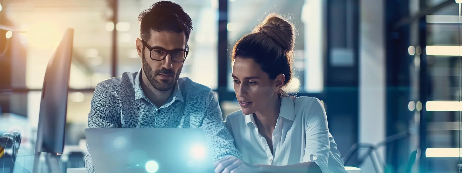 Two professionals reviewing digital marketing conversion data on a laptop
