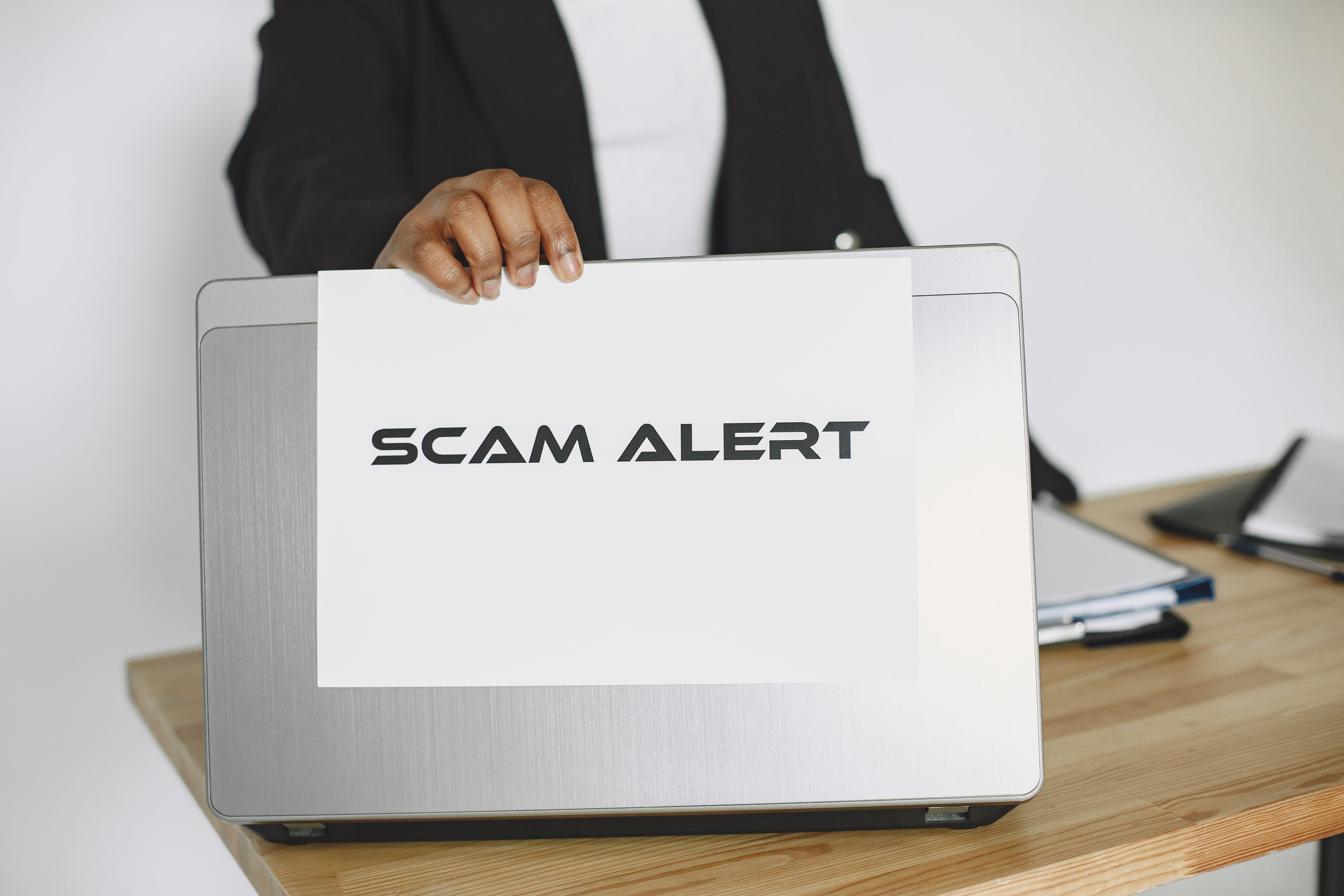 Scam alert warning on a laptop — spotting Upwork scams